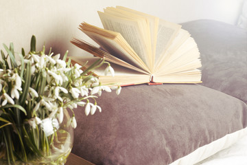 Open book on a pillow in bed. homeliness. old book. seamless texture of book pages. Vintage old books
