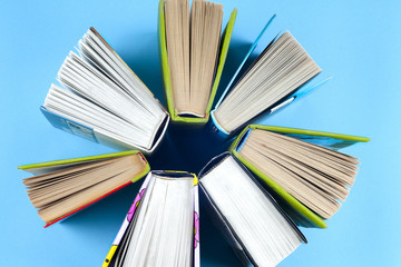 Naklejka premium Vintage old books on light background. Books and reading are essential for self improvement, gaining knowledge and success in our careers, business and personal lives.