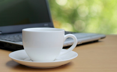 Cup of coffee on the wooden floor and bokeh background