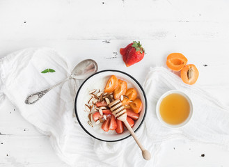 Healthy breakfast set. Rice cereal or porridge with fresh strawberry, apricots
