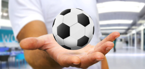 Businessman holding football in his hand