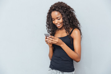 Smiling woman using smartphone