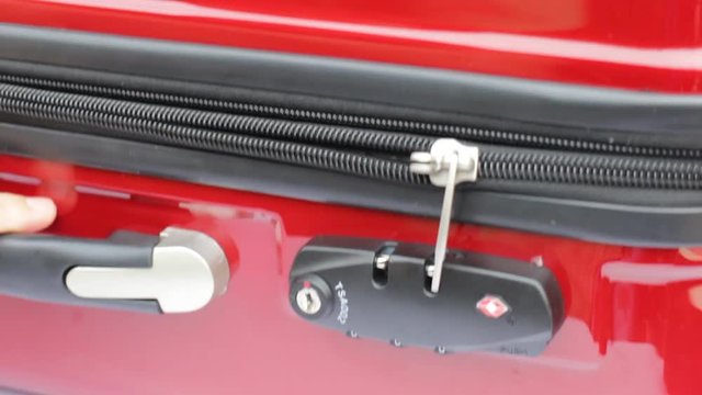 The zipper of the luggage being closed and locked, stock video