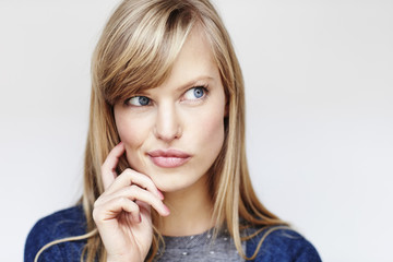 Blue eyed beautiful woman looking thoughtful