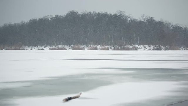 Snow covered frozen lake. Winter pond