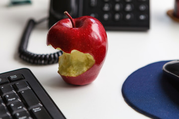 Apple on the table, healthy eating at work