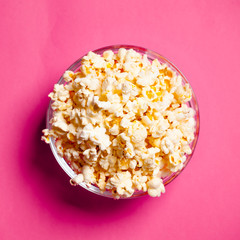 bowl with popcorn on red background