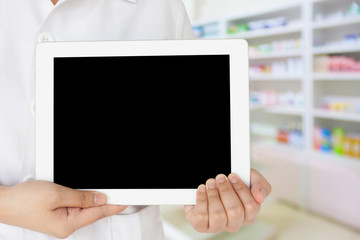 pharmacist showing tablet computer in the pharmacy