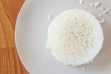 Steamed rice on white plate.