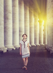 A beautiful young woman posing near St. Peter's square in Vatican, Rome. Vintage style picture