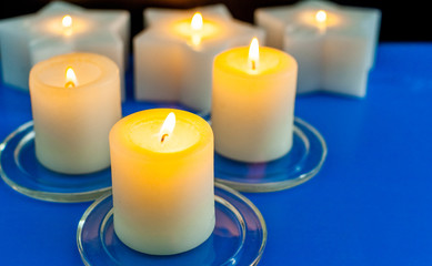 closeup to burning candles in darkness