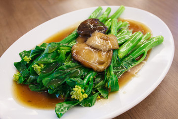 Stir-fried chinese broccoli and shiitake mushroom in oyster sauc