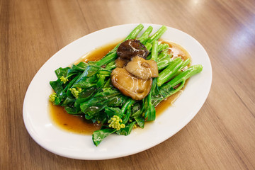 Stir-fried chinese broccoli and shiitake mushroom in oyster sauc