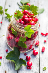 Glass jar full of fruits cherries and currants