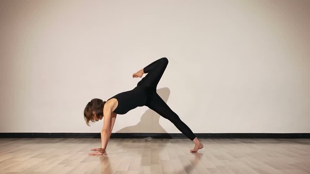 Female performing yoga asanas from downward dog to triangle pose part 2