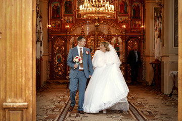 Beautiful newlyweds on wedding ceremony in the church
