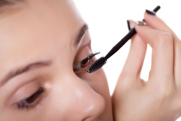 Young woman applying mascara - Makeup make-up