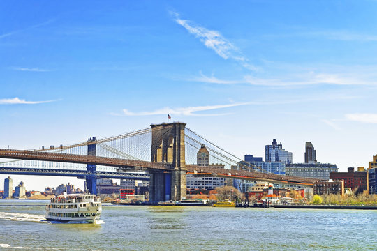 Ferry boat and Brooklyn bridge across East River
