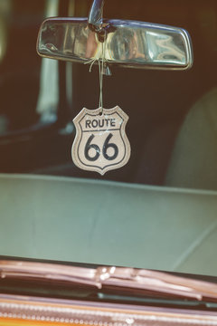 Route 66 badge hanging on a car mirror