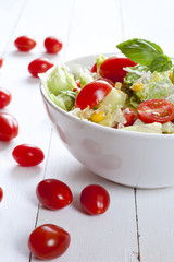 Tomato salad with cucumber, cheese and basil