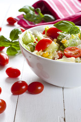 Tomato salad with cucumber, cheese and basil