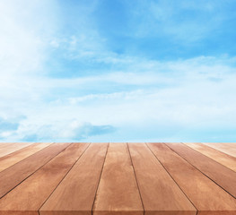 Wood table top on blue sky with clouds - used for display your products