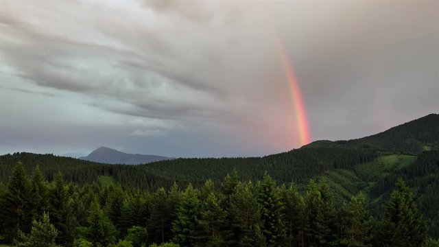 time lapse of beautiful rainbow moving over forest - sky after rain - amazing nature - full hd 1920 x 1080