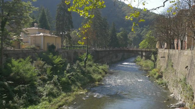 Bridge over river Cerna scenery of spa resort Herculane located in western Romania - Scenery in spa resort Herculane Romania 4K 3840X2160 UHD video 