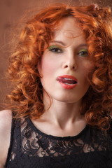 Portrait of beautiful woman with long curly red. Display languag