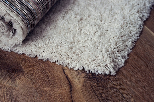White carpet on brown floor