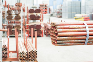 Stack of steel tubes in stock.