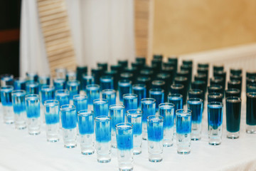 Blue shots served in ranges on the table