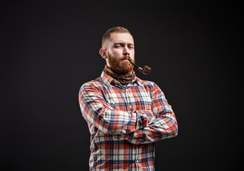 Portrait of bearded man smoking pipe 