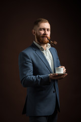 Portrait of man in suit smoking pipe