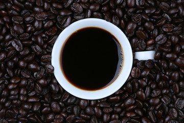 coffeebeans around white cup ,top view