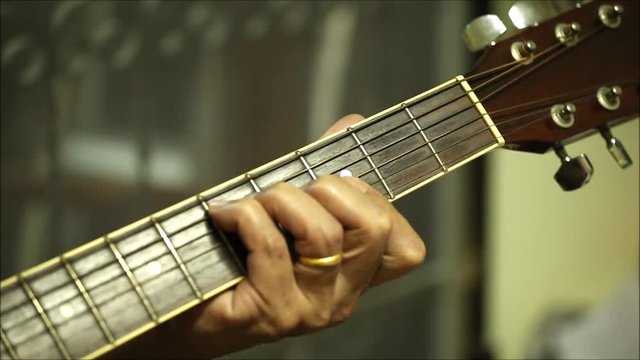 The Old man hand is playing guitar close up