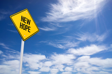 Naklejka premium New Hope Yellow Road Sign with Blue Sky Background
