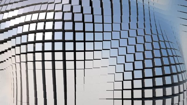A futuristic, seamless loop of a wall of shiny, metallic blocks rippling like a wave in a grid formation