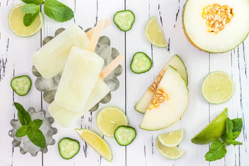 Refreshing mexican style ice pops - cucumber, lime, honeydew margarita paletas - popsicles. Top view,  overhead. Cinco de Mayo recipe - obrazy, fototapety, plakaty