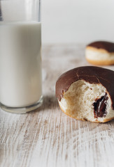Donuts with chocolate frosting and a glass of milk