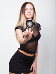 Fototapeta premium technology, internet and networking concept. beautiful woman in a short black skirt and a transparent top. woman presses shopping button on virtual screens