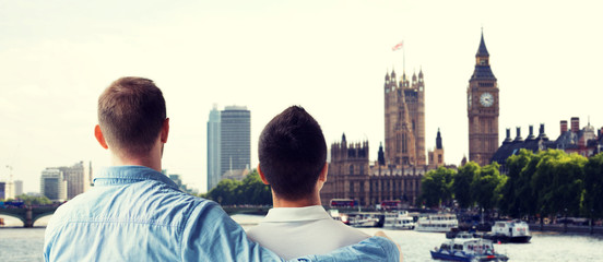 close up of male gay couple hugging over big ben