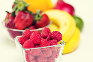 close up of fresh raspberry and fruits on table