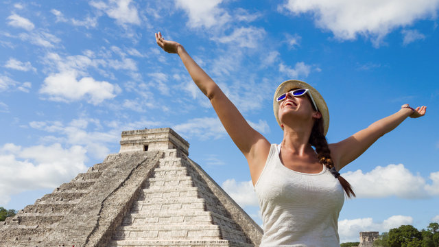 Happy woman enjoying travel tourism at Chichen Itza, Mayan Riviera, Mexico. Freedom and happiness on vacation.