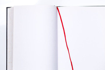 Blank open book with red ribbon