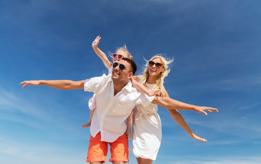 happy family having fun over blue sky background