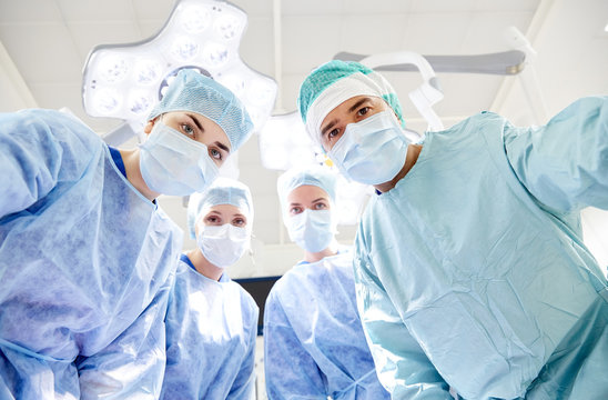 group of surgeons in operating room at hospital