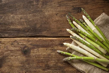 Poster Fresh asparagus on wooden background © Alexander Raths