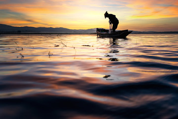 Fisherman of Bangpra Lake in action when fishing, Thailand.