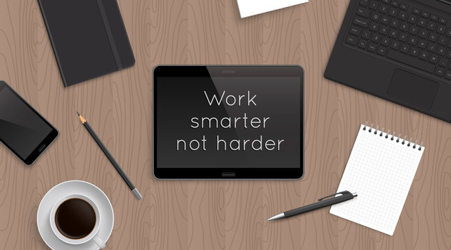 'Work smarter not harder' motivational and inspirational headline in tablet. Quote on the realistic office desktop top view with laptop, bloknot and diary and smartphone and coffee.